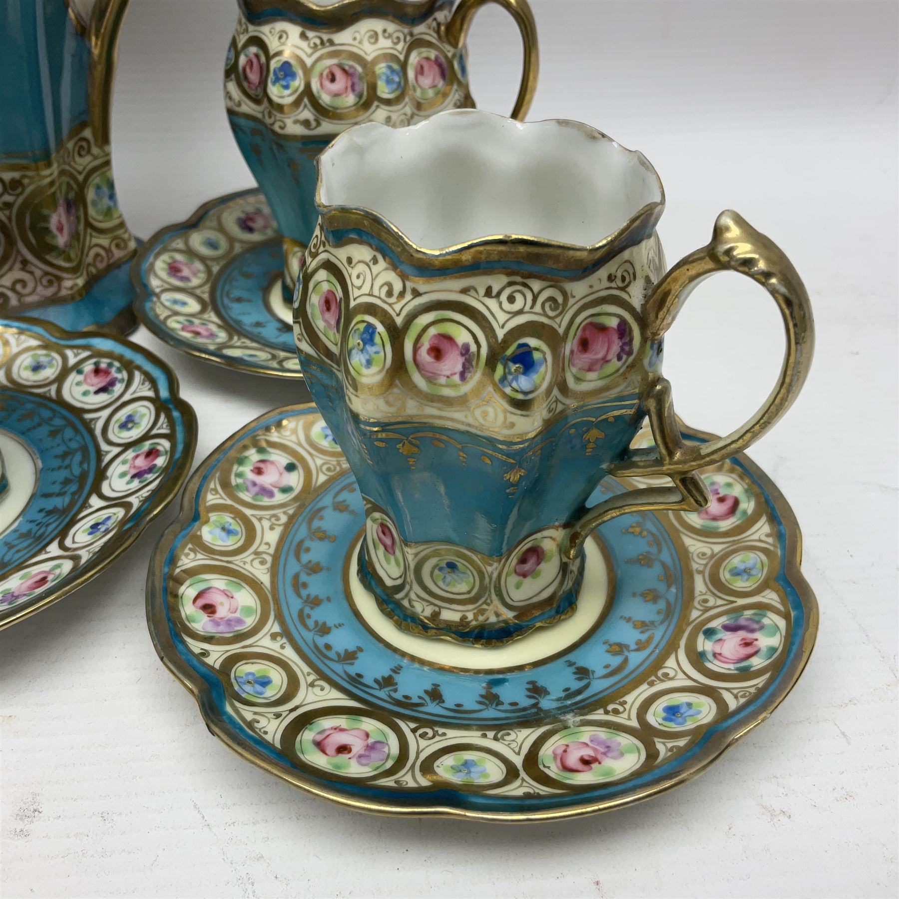 Noritake coffee service, hand painted with roses and gilt detail on a blue ground, comrosing coffee pot, five cups and saucers