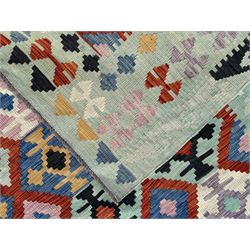 Kilim pastel ground rug, the field decorated with repeating multicoloured geometric diamond motifs, enclosed within matching geometric borders