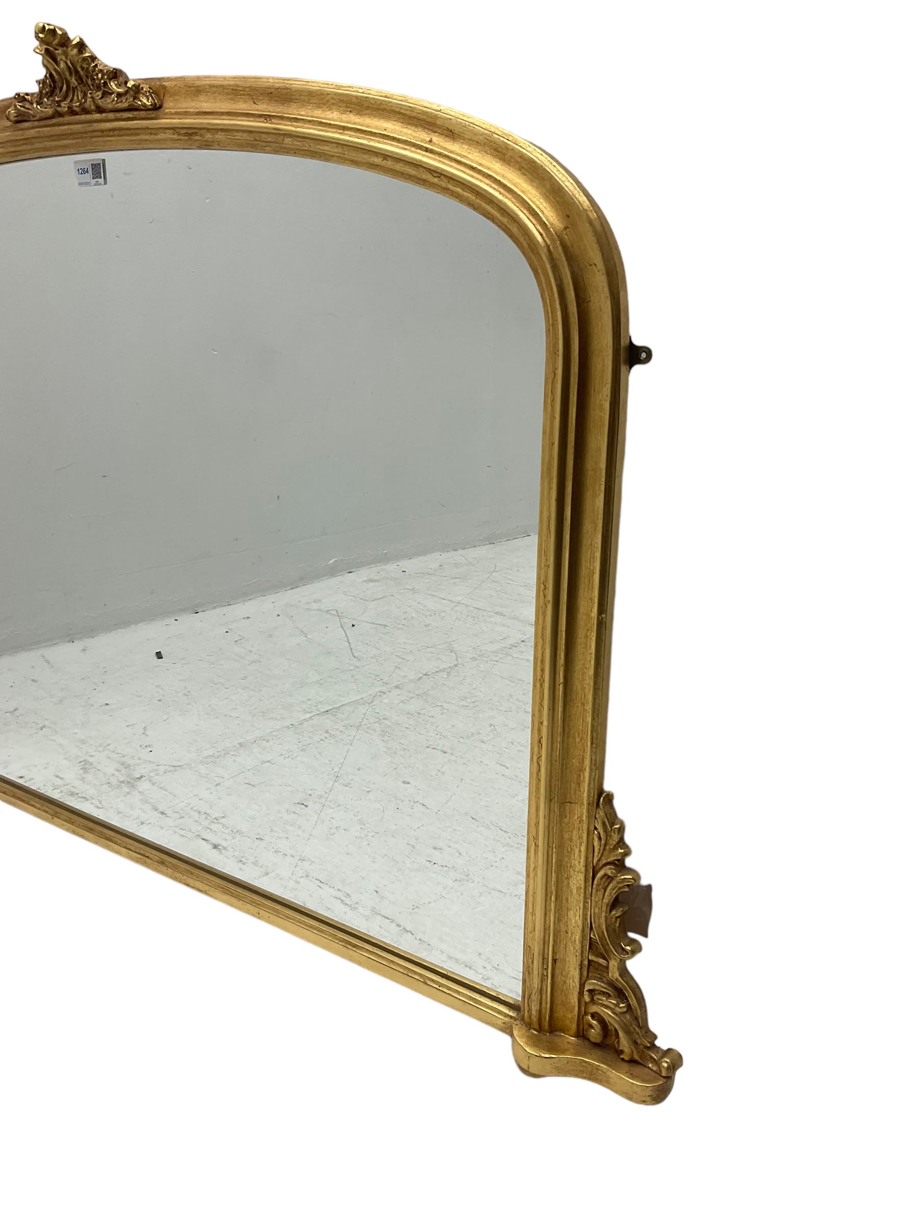 Victorian design gilt overmantel mirror, moulded arched frame with scrolled foliage cartouche pediment and brackets 