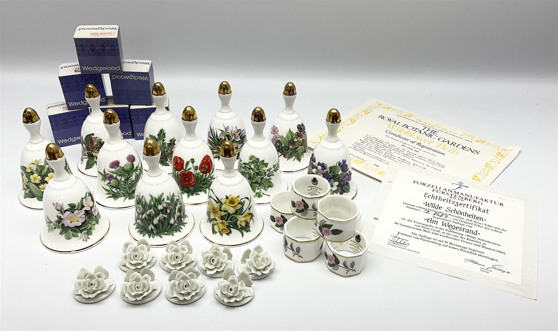 Set of twelve Danbury Mint Bells, together with place card holders and six Wedgwood napkin rings hathaway rose pattern