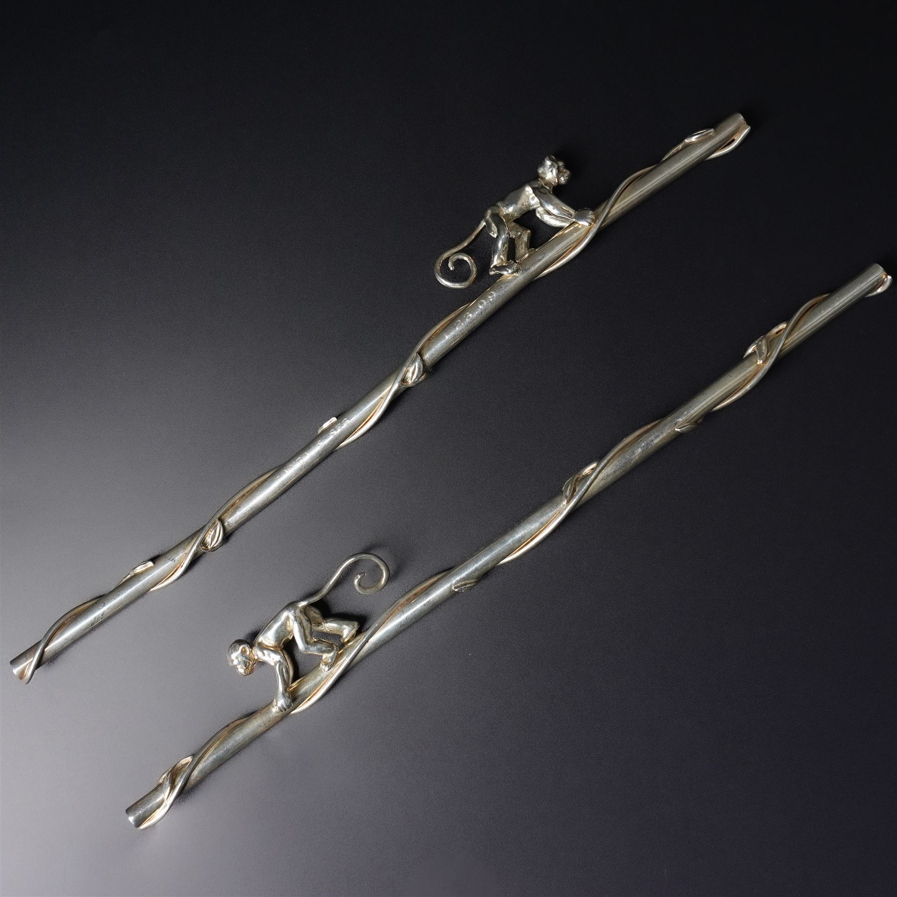 A pair of Tiffany & Co. novelty silver drinking straws, each modelled as a bamboo stem entwined with leaves and applied with a climbing monkey figure, engraved with names and date, stamped TIFFANY & CO. 925, W21cm