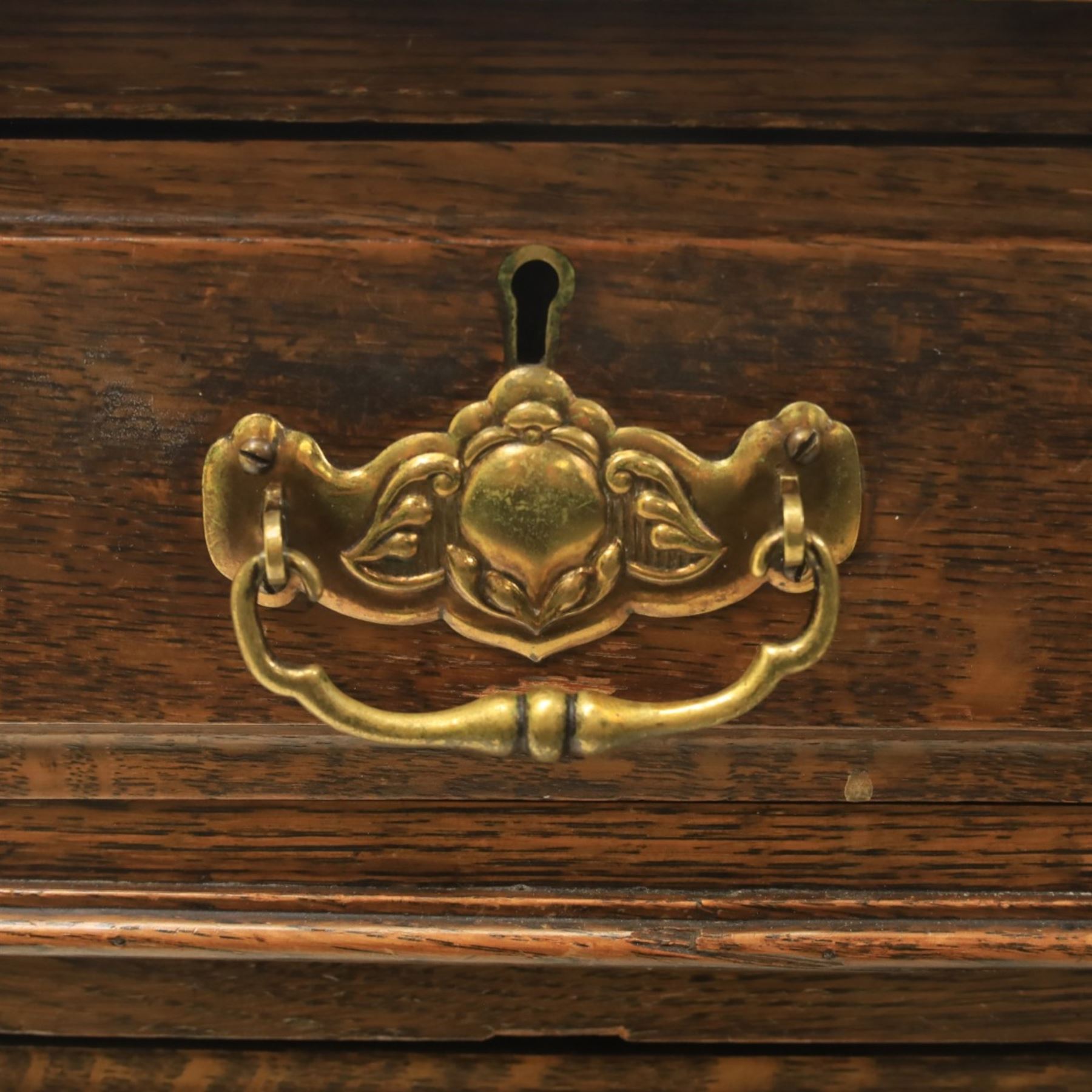 Oak twin pedestal desk with leather top, moulded rectangular top with inset black leather writing surface, nine fielded panelled drawers with brass handles, raised on a plinth base with castors