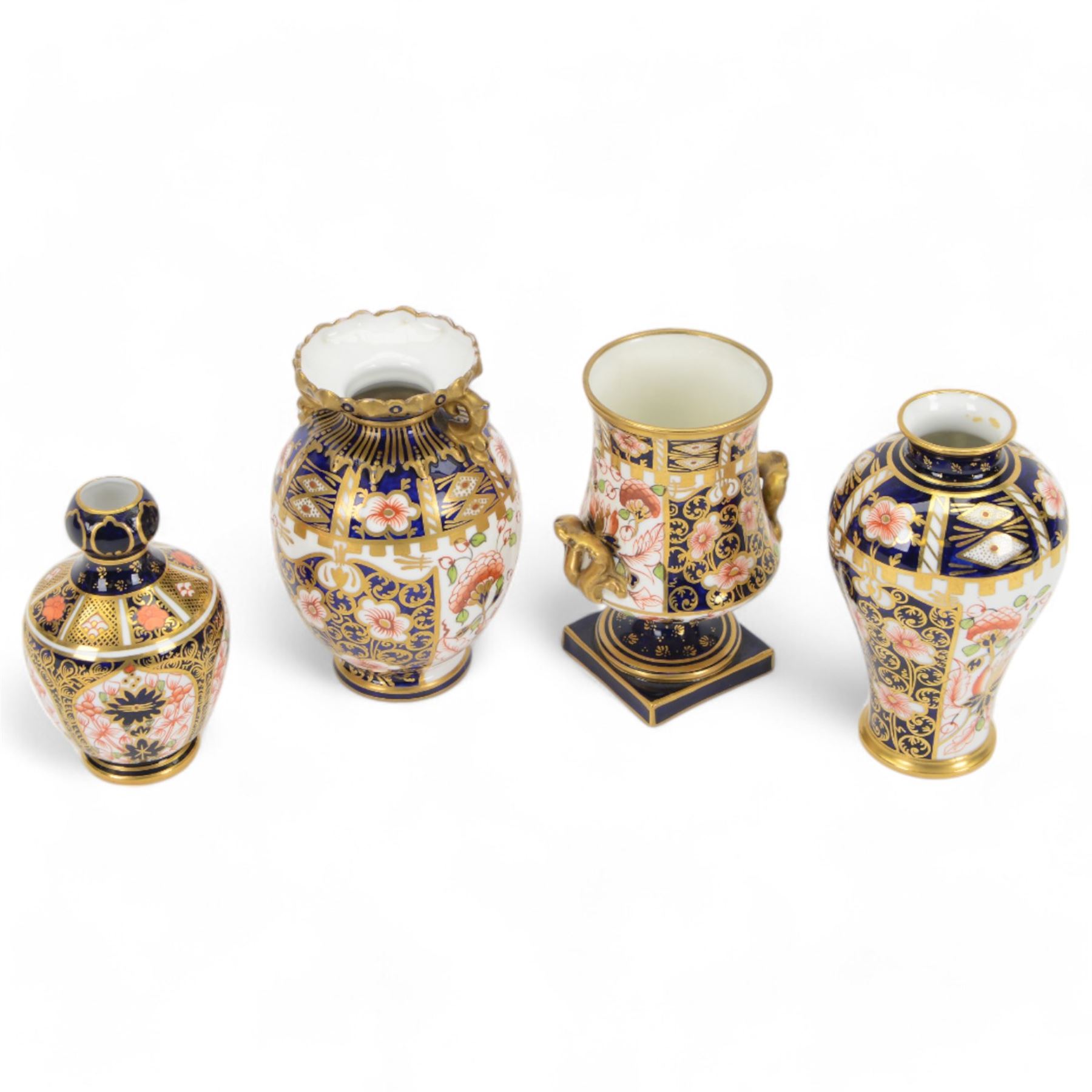 Four Royal  Crown Derby vases in imari patterns, including baluster vase with fluted rim in pattern no 6299, twin handled vase on a square base etc 
