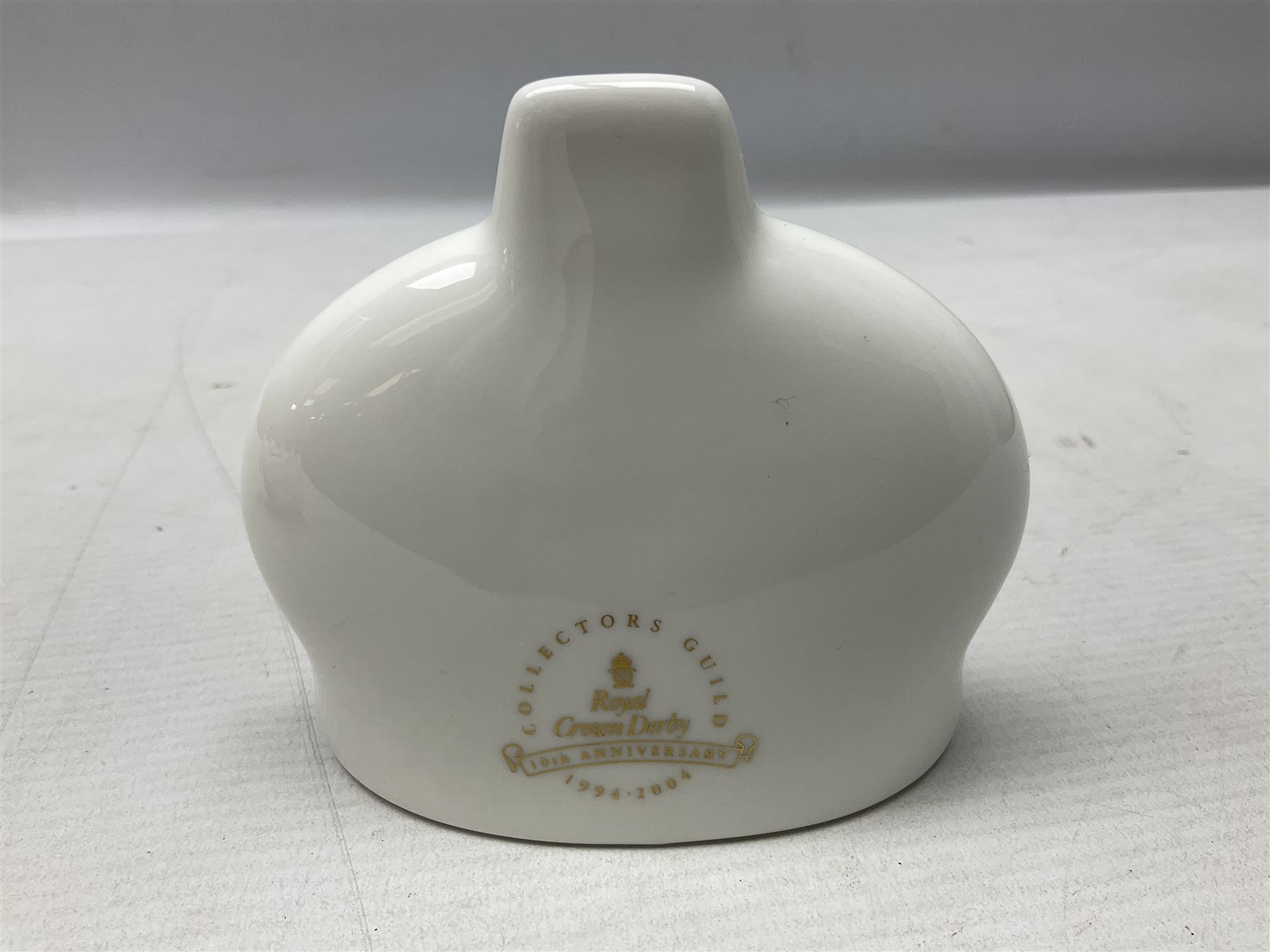 Four Royal Crown Derby teddy paperweights, comprising Teddy Cook, two Teddy George and Seated Teddy, all without stoppers, together with Crown Namestake with gold stopper 