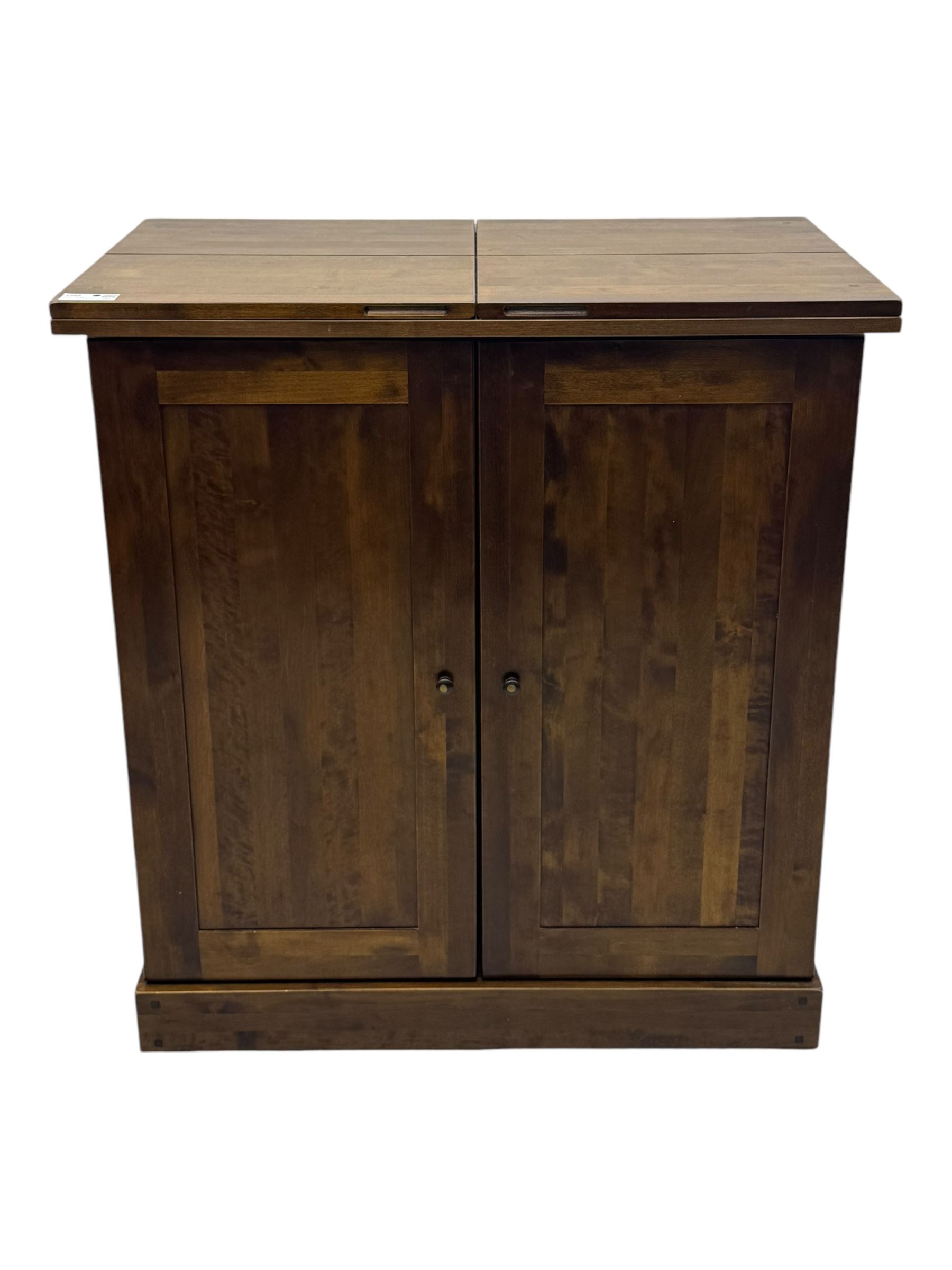 Laura Ashley - contemporary 'Garret' birch and dark chestnut finish bar cabinet, rectangular top with fold-out sides, double front doors enclosing shelving, wine racks, and glass storage, built-in stemware racks and bottle compartments, raised on plinth base