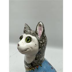 Émile Gallé (French 1846-1904): Faience model of a cat, naturalistically modelled, the head inset with green marbled glass eyes, glazed and painted with flowers on blue ground, the neck decorated with a pendant brooch bearing a portrait of a dog, signed beneath H34cm