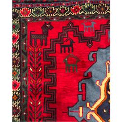 Northwestern Persian Cirjan hand-knotted carpet, madder red field with three linked stepped lozenge medallions in blue, ivory and green, flanked by angular motifs within a dark green border of serrated leaves and rosettes 