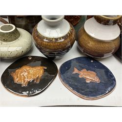 Wold studio pottery tankards, in various colours and relief decoration together with other studio items including vases, jugs and pots 