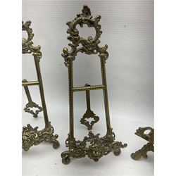 Nine ornate cast brass easel stands of various sizes, H24cm
