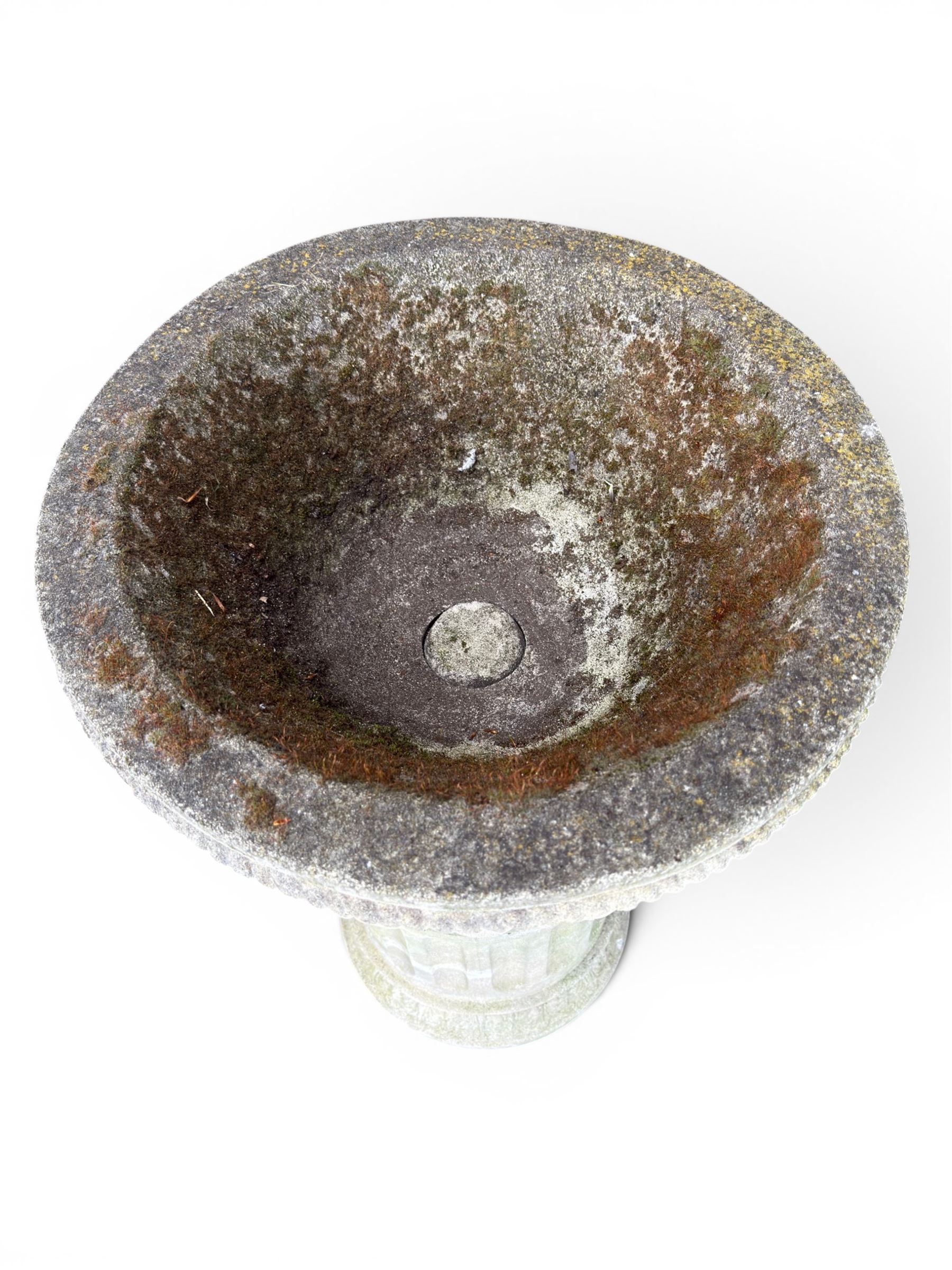 Four 20th century good quality weathered cast stone pedestal urns, circular lobed bowls with rope twist and lattice border, raised on squat base with fluted columns