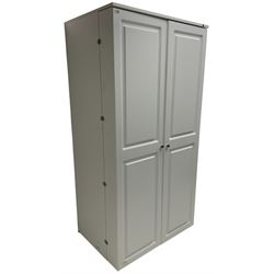 Large white finish sewing cabinet, enclosed by two doors fitted with thread holders and shelves, the interior fitted with shelves and sliding trays, with fold down work surfaces 