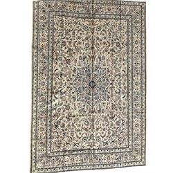 Persian Nain ivory ground carpet, the central rosette medallion surrounded by all over trailing indigo scrolling and foliate decoration with palmettes, the guarded border decorated with repeating Shah Abassi motifs, with stylised flower heads within the bands