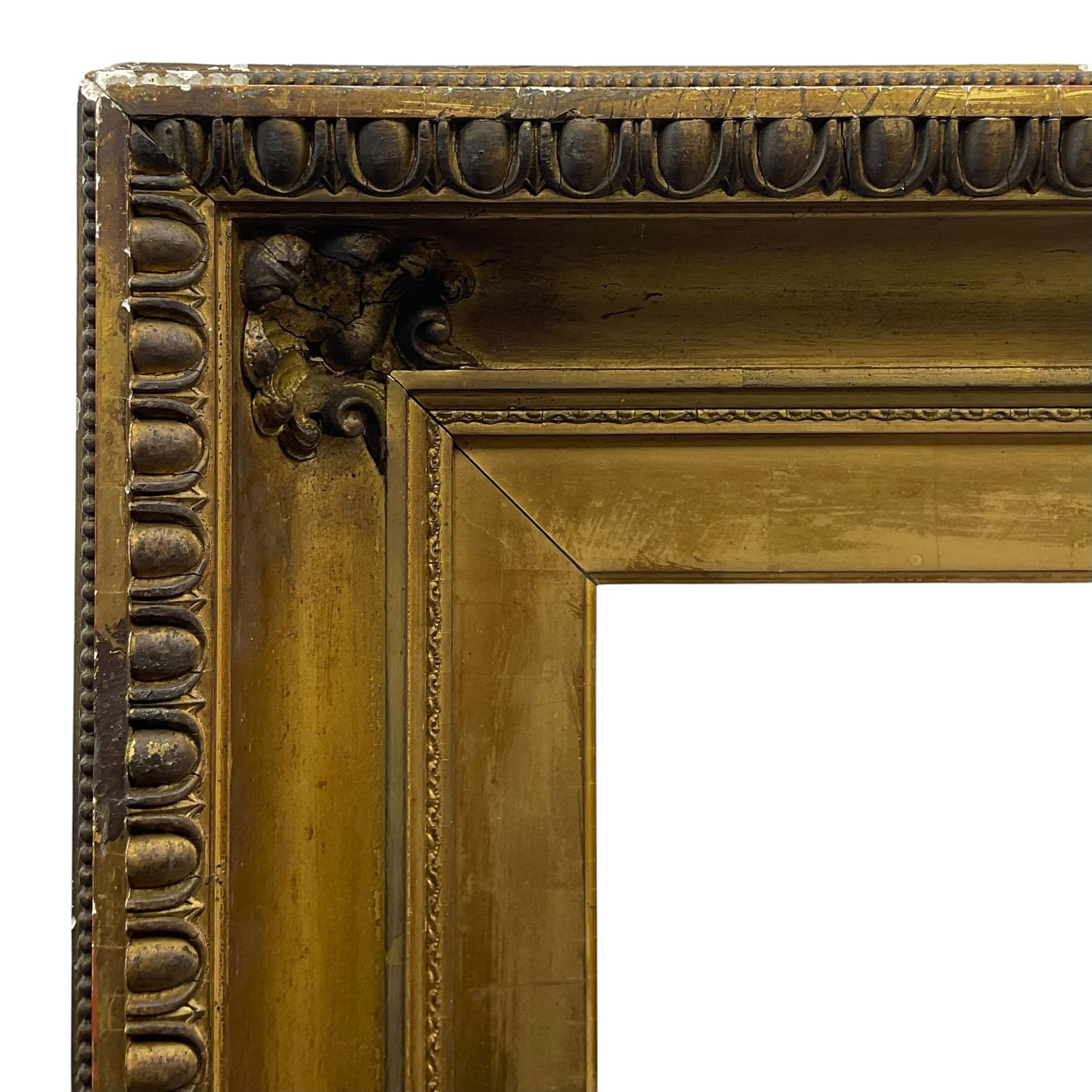 Large early 20th century gilt picture frame, with floral moulded corners and egg and dart moulding to the edge, aperture 78cm x 98cm, inner slip aperture 70cm x 91cm, overall 97cm x 118cm