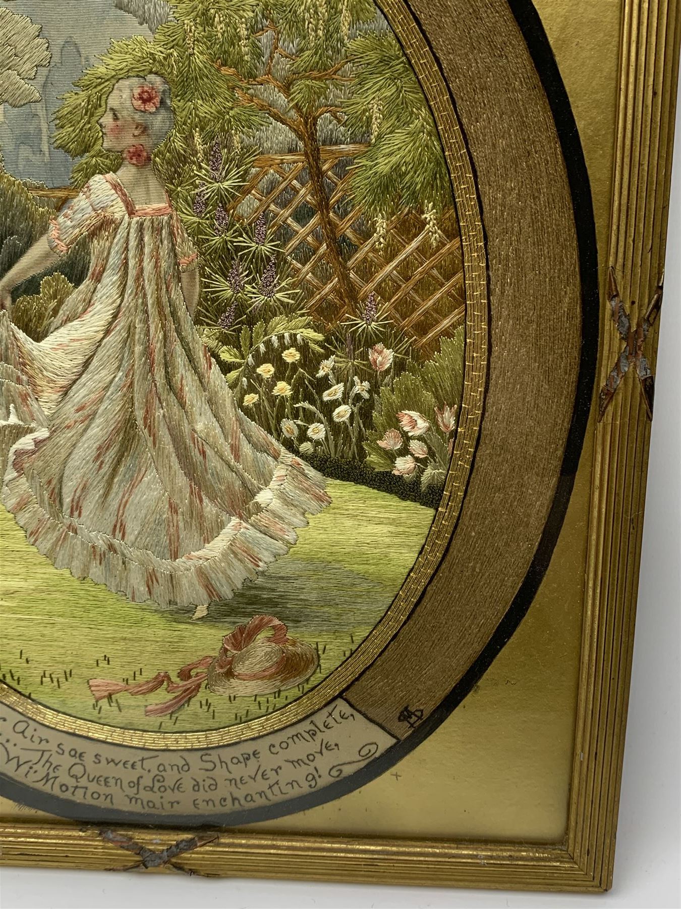 George III silkwork picture, of oval form depicting a female figure in garden setting, within a silkwork border detailed with verse from Robert Burns Bonnie Peg, 'Her air sae sweet, and shape complete, The Queen of Love did never move, Wi' Motion mair enchanting!', and monograms 'FV' and 'SM', in reeded gilt frame and gilt mount, indistinctly inscribed in pencil verso, overall H36cm L30.5cm