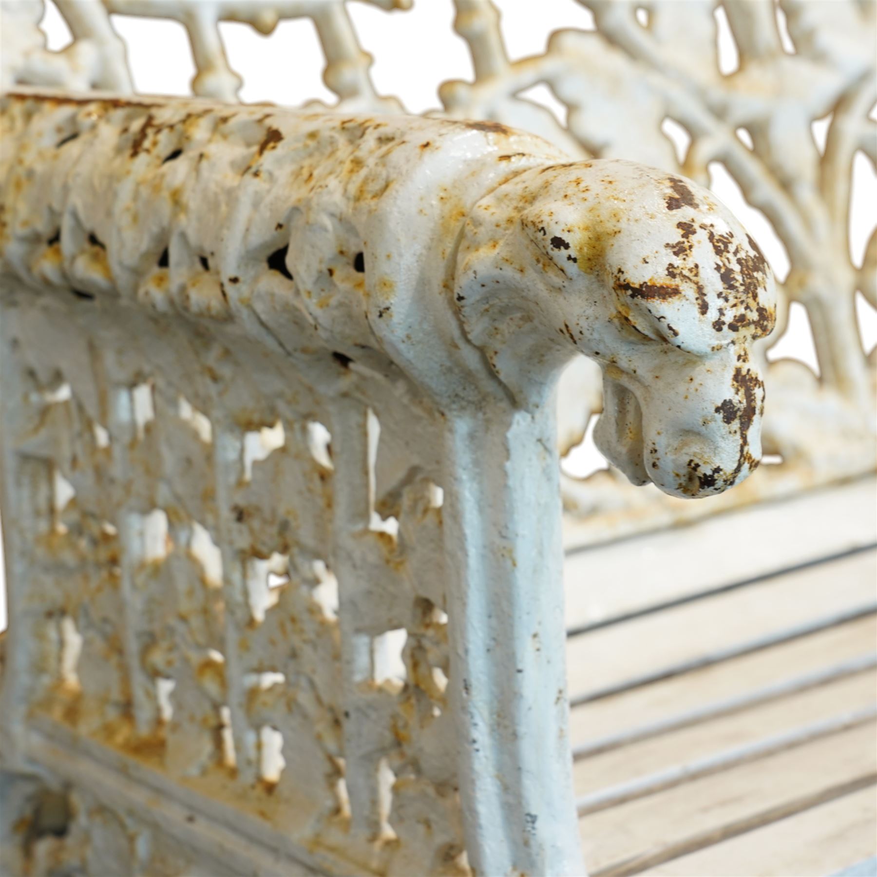 Coalbrookdale design - early 20th century cast iron oak leaf and acorn bench, white painted cast iron frame with slatted wooden seat, the pierced and shaped back decorated with scrolling oak branches and leafage, flanked by dog mask arm terminals over cabriole supports with paw feet 