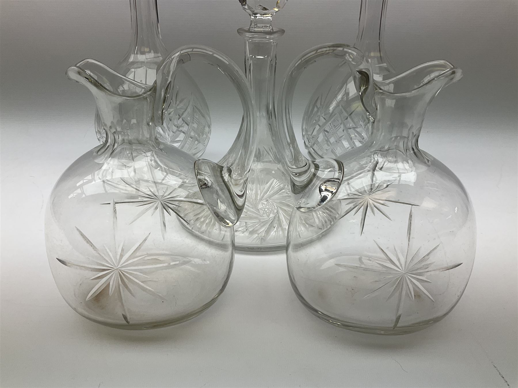Pair of cut glass decanters and stoppers, together with a cut glass ships decanter and stopper, and pair of claret jugs with star cut decoration to bodies, in one box, (5)