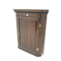 19th century oak wall hanging corner cupboard, projecting cornice with dentil frieze, single door enclosing two shaped shelves