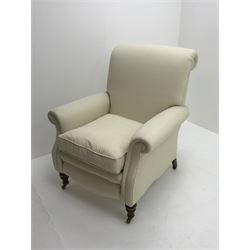 Victorian style scroll back armchair upholstered in cream fabric, turned supports on castors