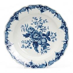 First Period Worcester plate, decorated in the Pine Cone pattern, cresent mark beneath D22.5cm, together with an 18th century Delft plate, painted with a Chinese figure by a fence, D23cm (2)