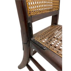 Early 19th century stained beech and mahogany child's correction chair, cane seat and back raised on turned supports united by stretchers