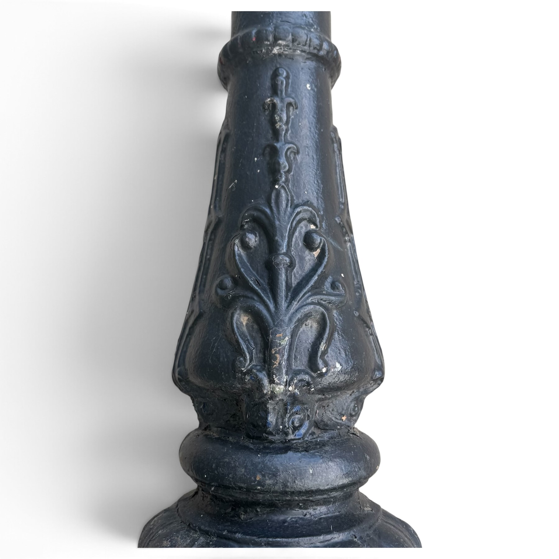 REVO Electric Co. Ltd., Tipton - early 20th century cast iron street lamp standard, the later hexagonal lantern with amber leaded glazing and pointed finial, supported on a swan-neck bracket above a ring-turned capital, tapering column and ladder rest, terminating in a moulded scrolling foliate-decorated base with lappet collar, stamped REVO

Provenance: formerly installed as street lighting in Prestwich, Greater Manchester