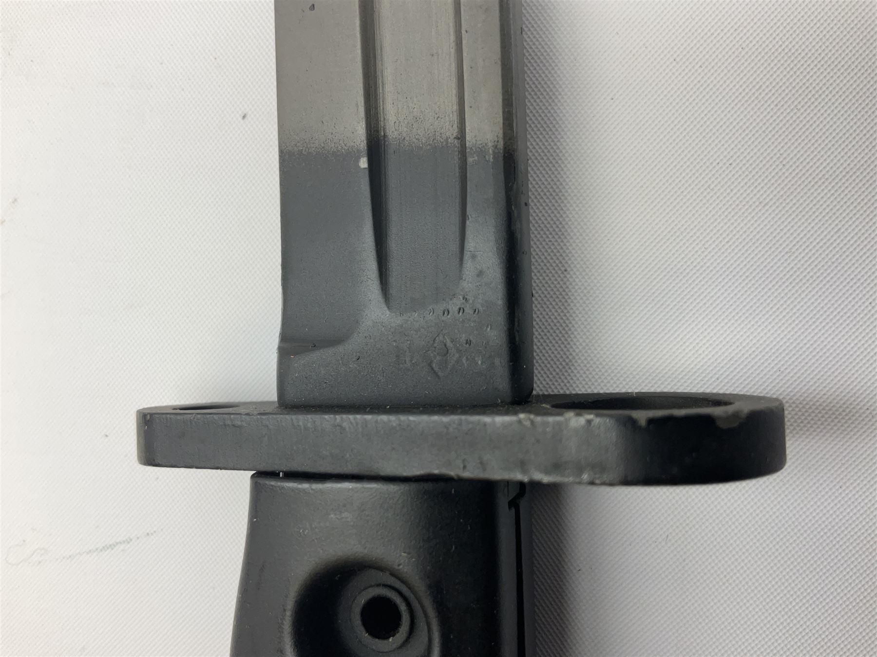 British Army L1A3 SLR Self Loading Rifle bayonet, with 20.5cm Bowie type fullered blade, hooked pommel with working push release button, grip secured by two deeply recessed rivets and marked L1A3 9600257 D71; in matching black scabbard L32.5cm overall