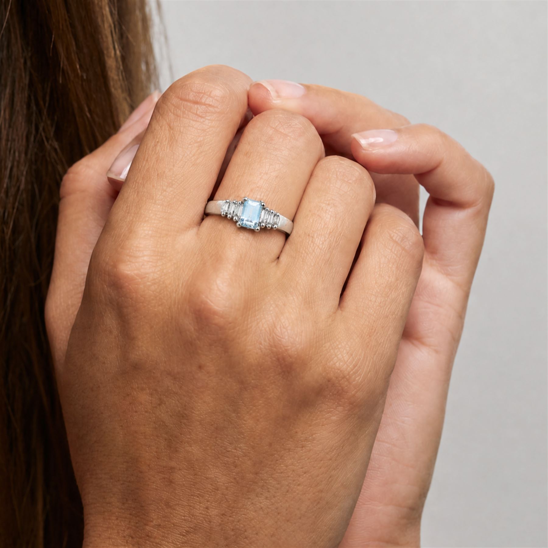 10ct white gold aquamarine and diamond ring, single octagonal cut aquamarine of approx 0.45 carat, with three tapered baguette cut diamonds set either side, stamped