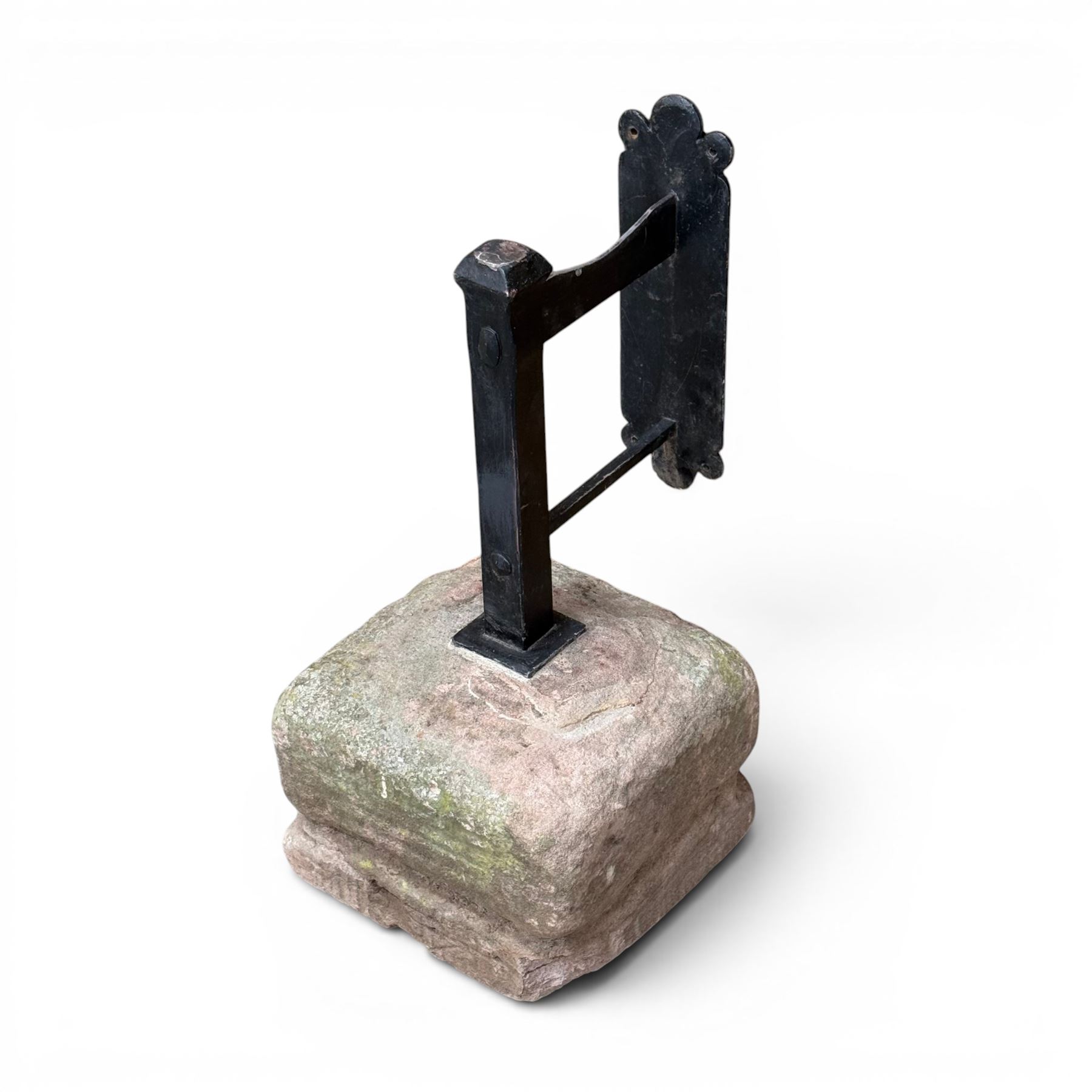 Large wrought metal boot scraper in black painted finish, set in formed stone plinth