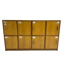 20th century oak bank of lockers, fitted with eight locker cupboard doors each enclosing single shelf, on plinth base