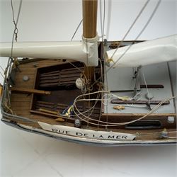 Scratch built model yacht 'Rue de la mer', with painted blue and white hull, with acrylic case, model H67.5cm