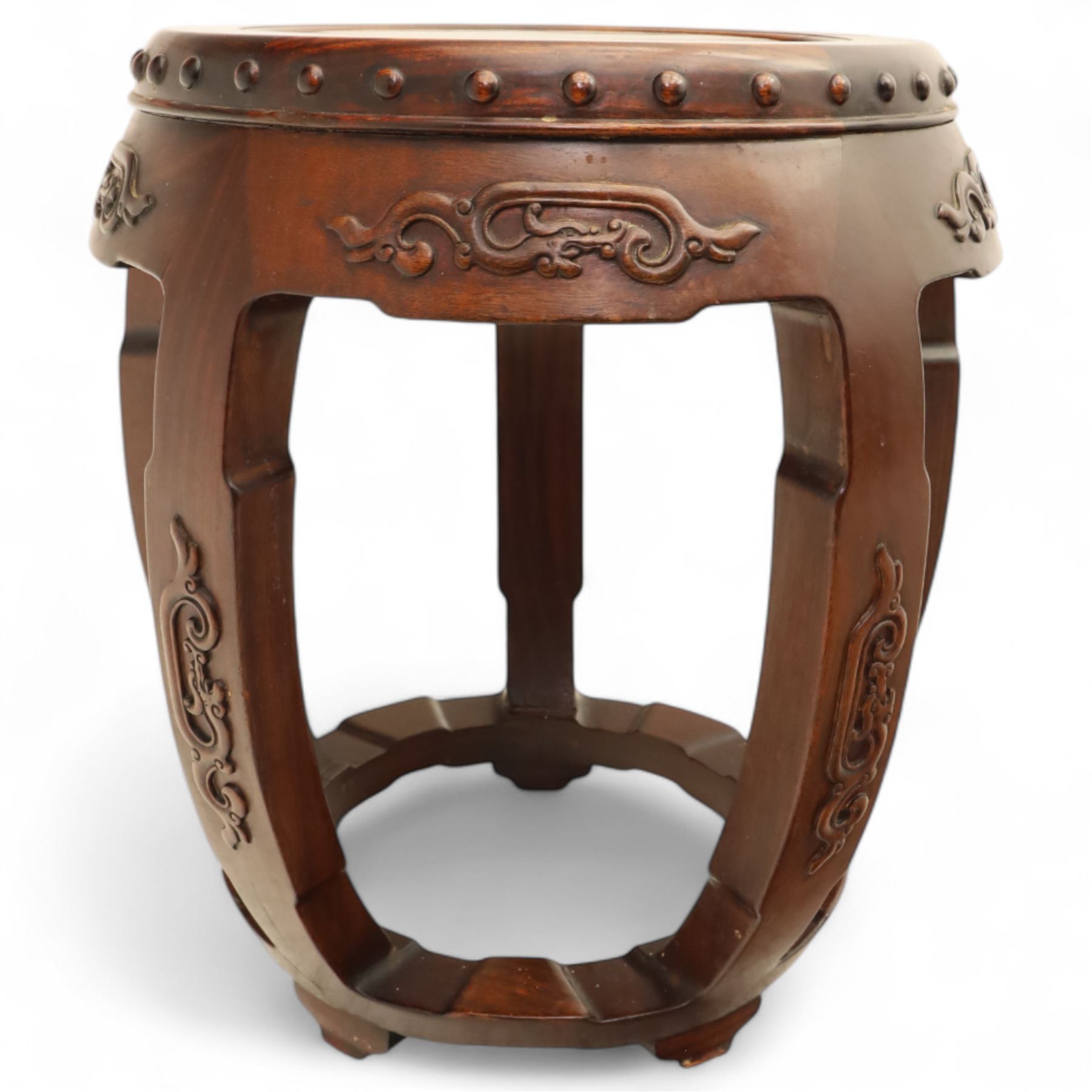 Pair of early 20th century Oriental hardwood barrel seats, of drum form with shaped apron and pierced panels, carved with stylised scrollwork and studded detail to the top