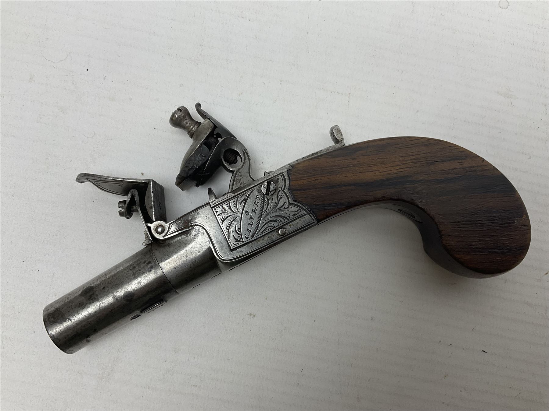 Early 19th century J. Calvert (Leeds) flintlock single barrel tap action pocket pistol, approximately .45 cal., the 4cm (originally) screw off barrel with top safety and walnut stock L16cm overall