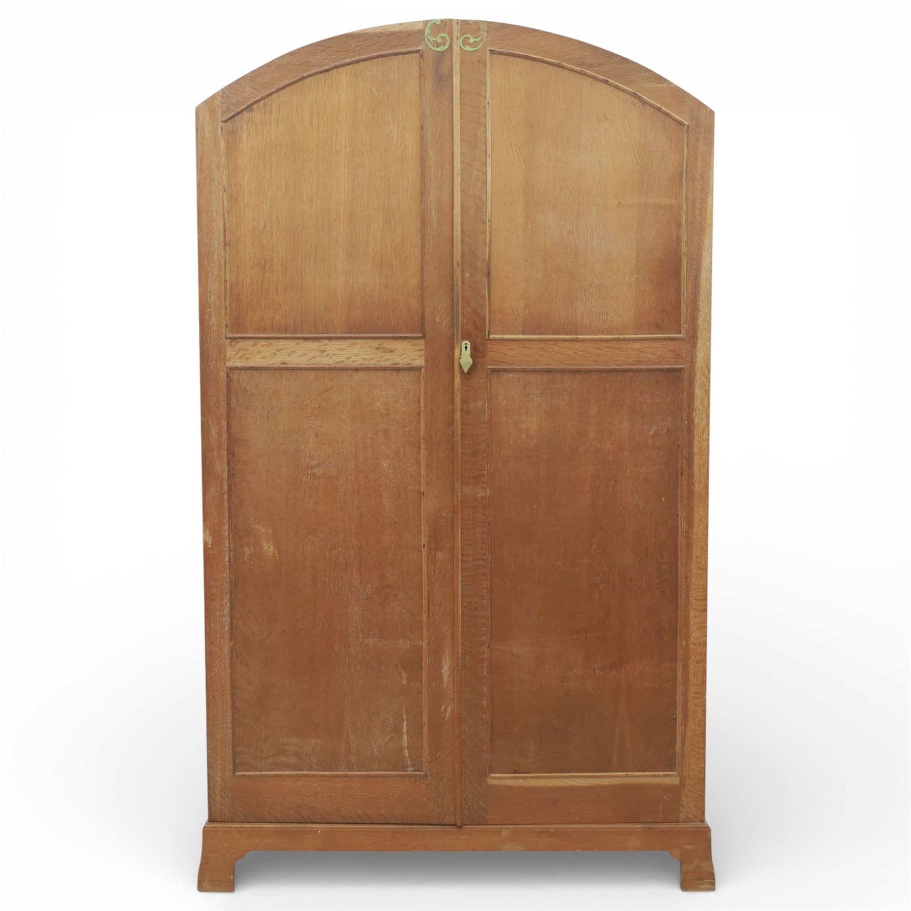 Early 20th century Art Deco bedroom suite, comprising double wardrobe, dressing table and chest of drawers, constructed in walnut with figured veneers and geometric banding, the wardrobe with arched top and panelled doors enclosing a fitted interior, the dressing table with rectangular top below a three panel mirror arrangement, fitted with two short over two long drawers, the chest with three short and three long drawers, each piece fitted with faceted handles and raised on shaped feet
Wardrobe (H 177cm, D 46cm, W 112cm)
Chest (H 85cm, D 48cm, W 92cm)
Dressing table (H 160cm, D 52cm, W 106cm)
