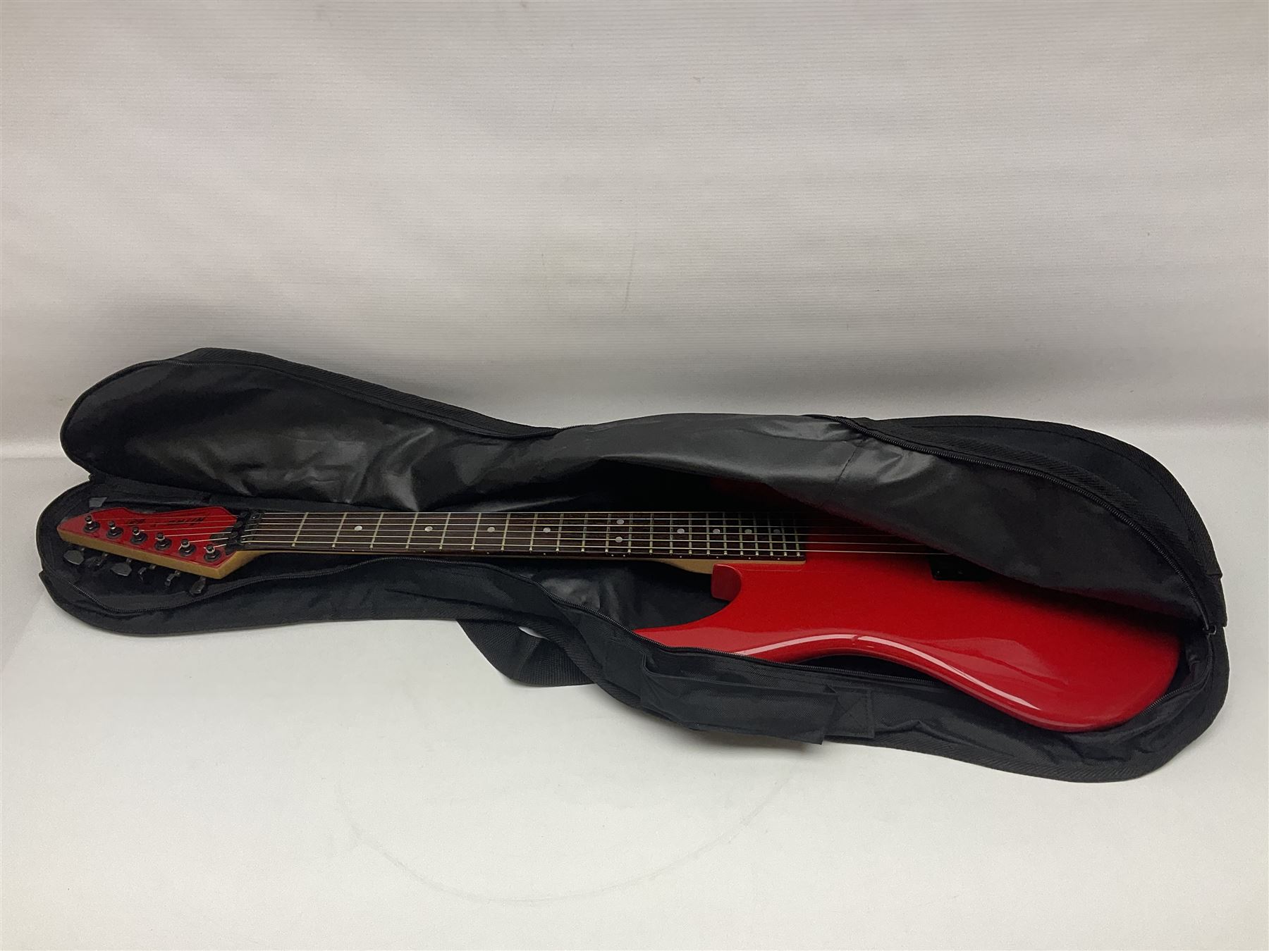 American Peavey Nitro 1 hand-made electric guitar in red with Kahler tremolo, serial no.02786479, L98cm overall; in soft carrying case.