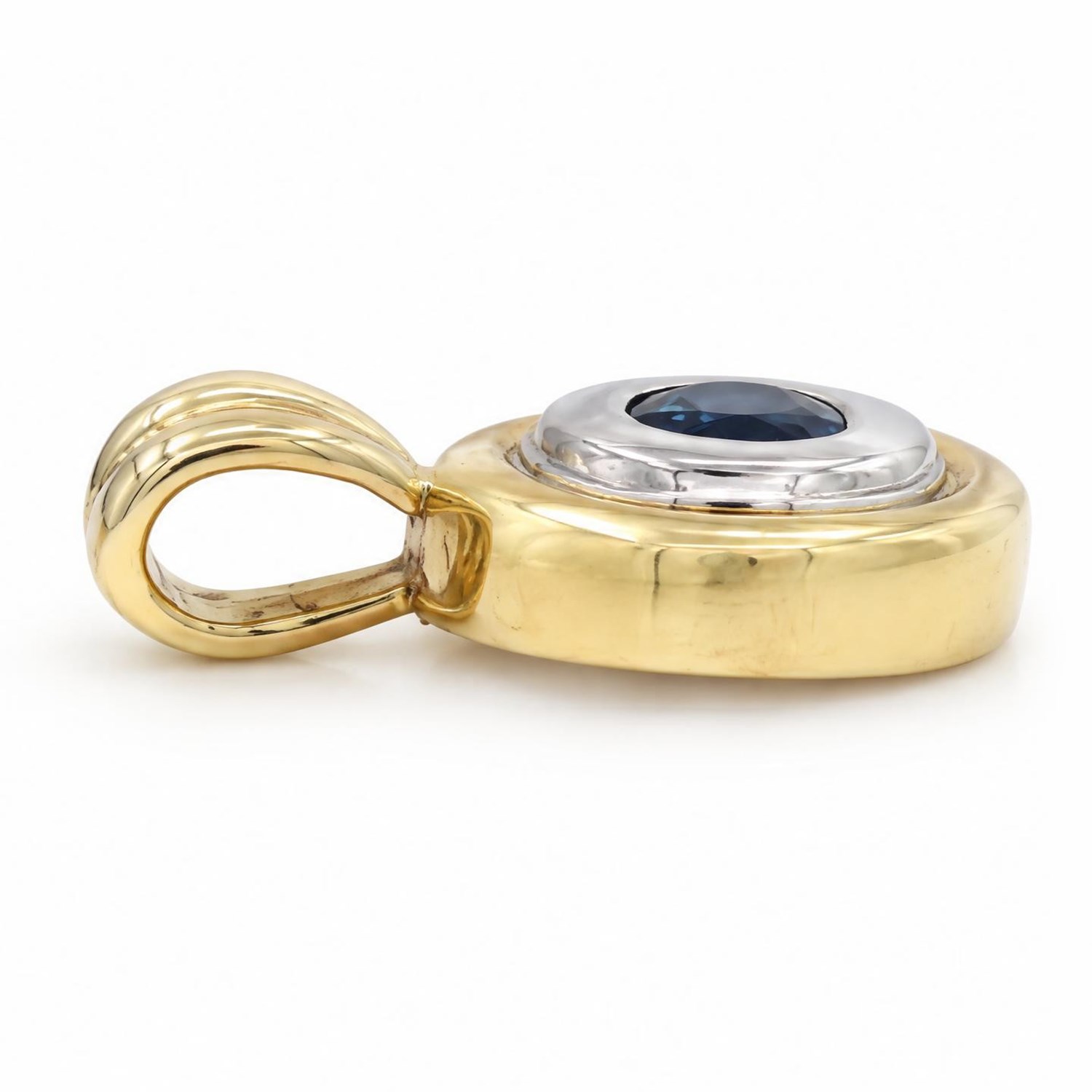 Pair of 14ct gold synthetic sapphire earrings and pendant, each rubover set with a single oval cut sapphire, within a white and yellow gold oval surround