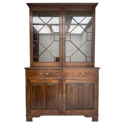 Acorn Industries - Georgian design mahogany bookcase on cupboard, fitted with two astragal glazed doors enclosing three glass shelves, base with two cock-beaded drawers over two panelled cupboards, inlaid with acorn signature, by Alan Grainger, Brandsby