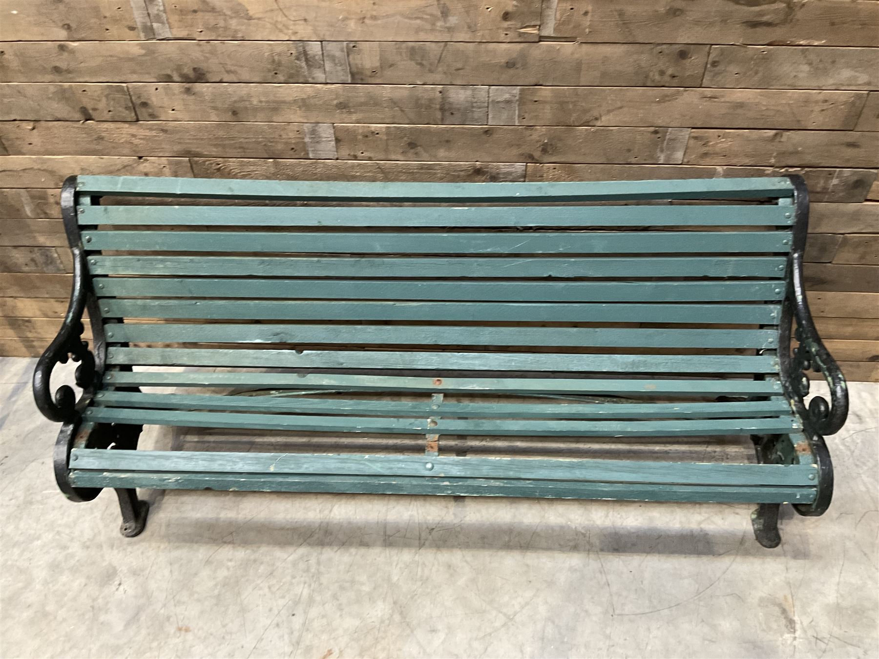 Early 20th century slatted garden bench with scrolling cast iron bench ends