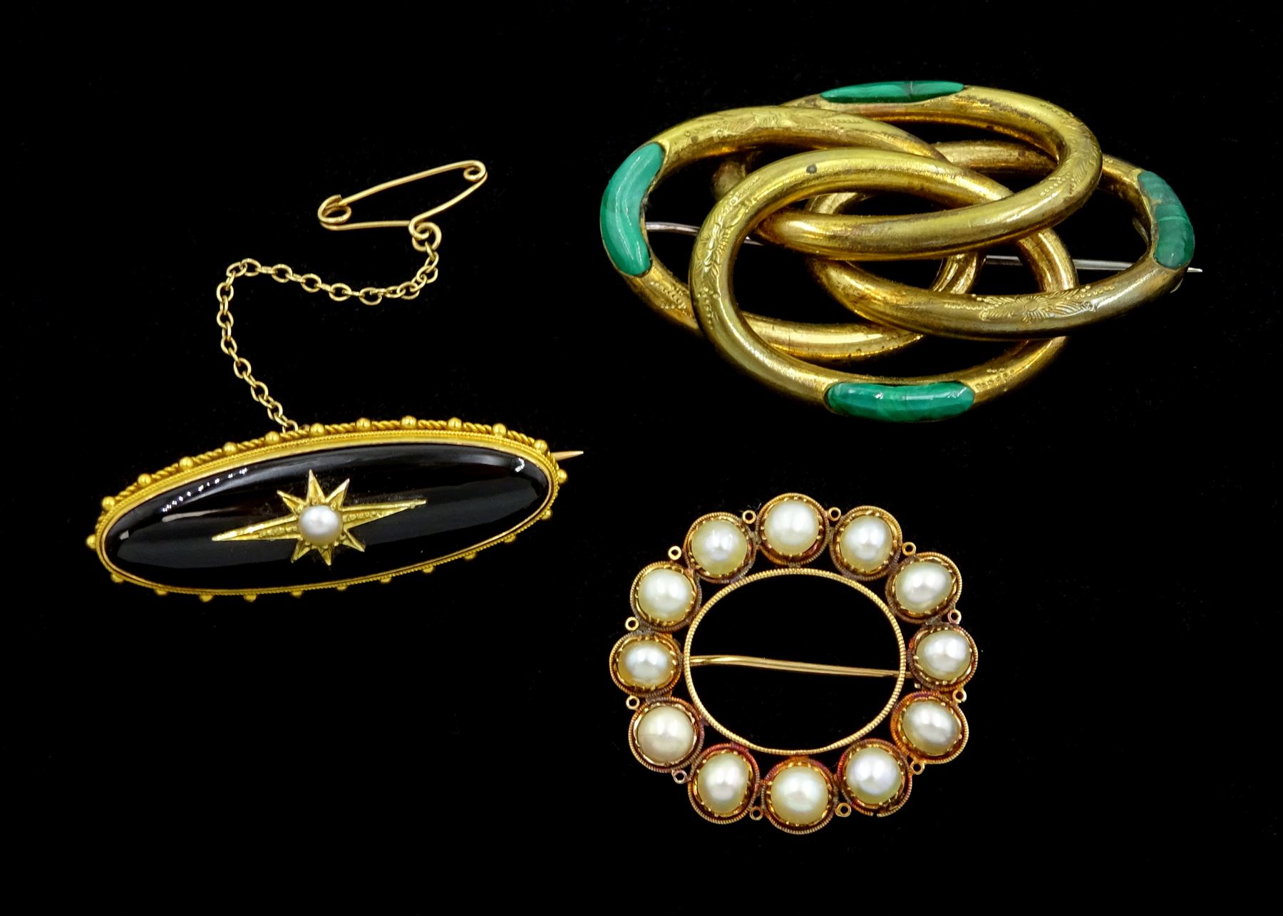 Edwardian gold black onyx brooch, with applied gold pearl set star, the glazed back with hairwork and engraved 'JB March 10th 1904', 18ct gold split pearl oval brooch and a gilt malachite brooch