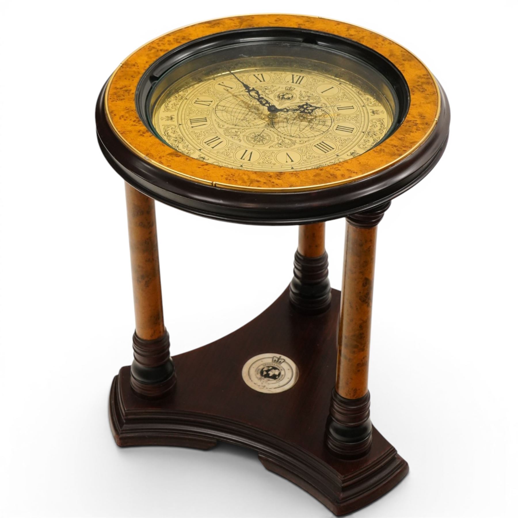 Royal Geographic Society - clock occasional table, the inset brass face with double hemisphere design and glazed top, raised on cylindrical supports united by triform platform base