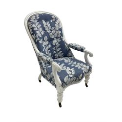 Victorian white painted open armchair, upholstered in blue fabric decorated with trailing leaf pattern, scrolled arm terminals on turned front supports with castors