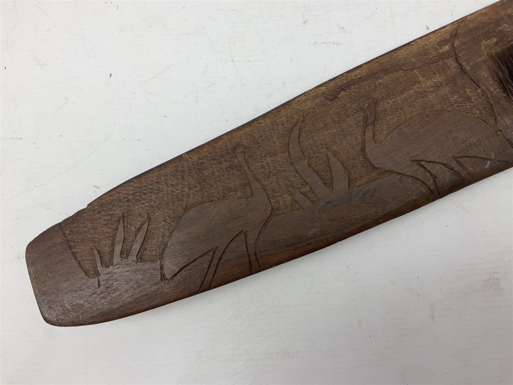 Australian Aboriginal shield, carved with Kangaroo and Emu, 74.5cm; Spear painted with aquatic creatures 78cm, and Spear thrower 81cm (3)