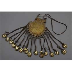 Late 19th/early 20th century African brass pouch shaped body with sliding cover decorated with shapes, hung with cowrie shells on leather straps, H19cm   