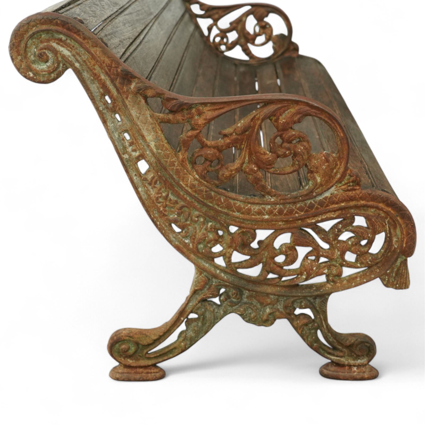 19th century oak and cast iron garden bench, shaped back and seat formed from curved wooden slats secured with dome rivets, pierced cast iron supports with foliate decoration 