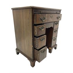 Georgian walnut kneehole desk, moulded rectangular top with book-matched veneers within crossbanding, fitted with slide over one long drawer, frieze drawer, six small drawers and recessed cupboard, raised on bracket feet