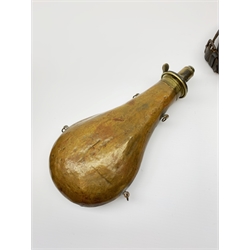 Victorian large copper powder flask embossed with a hunting scene within an oak leaf border with stag and fox heads, the nozzle marked 'Extra Quality Sykes Patent', fitted with four suspension rings H24cm; together with Victorian leather shoulder shot flask with Sykes nozzle L80cm (2)