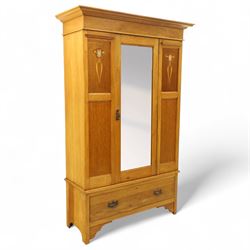 Art Nouveau oak wardrobe, central mirrored door flanked by panels inlaid with stylised tulip motifs, fitted with hanging rail and hooks, single drawer to base with brass handles