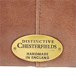 Distinctive Chesterfield - full buttoned tan brown leather sofa, deep buttoned back, seat and arms, raised on dark stained supports terminating in brass castors 
