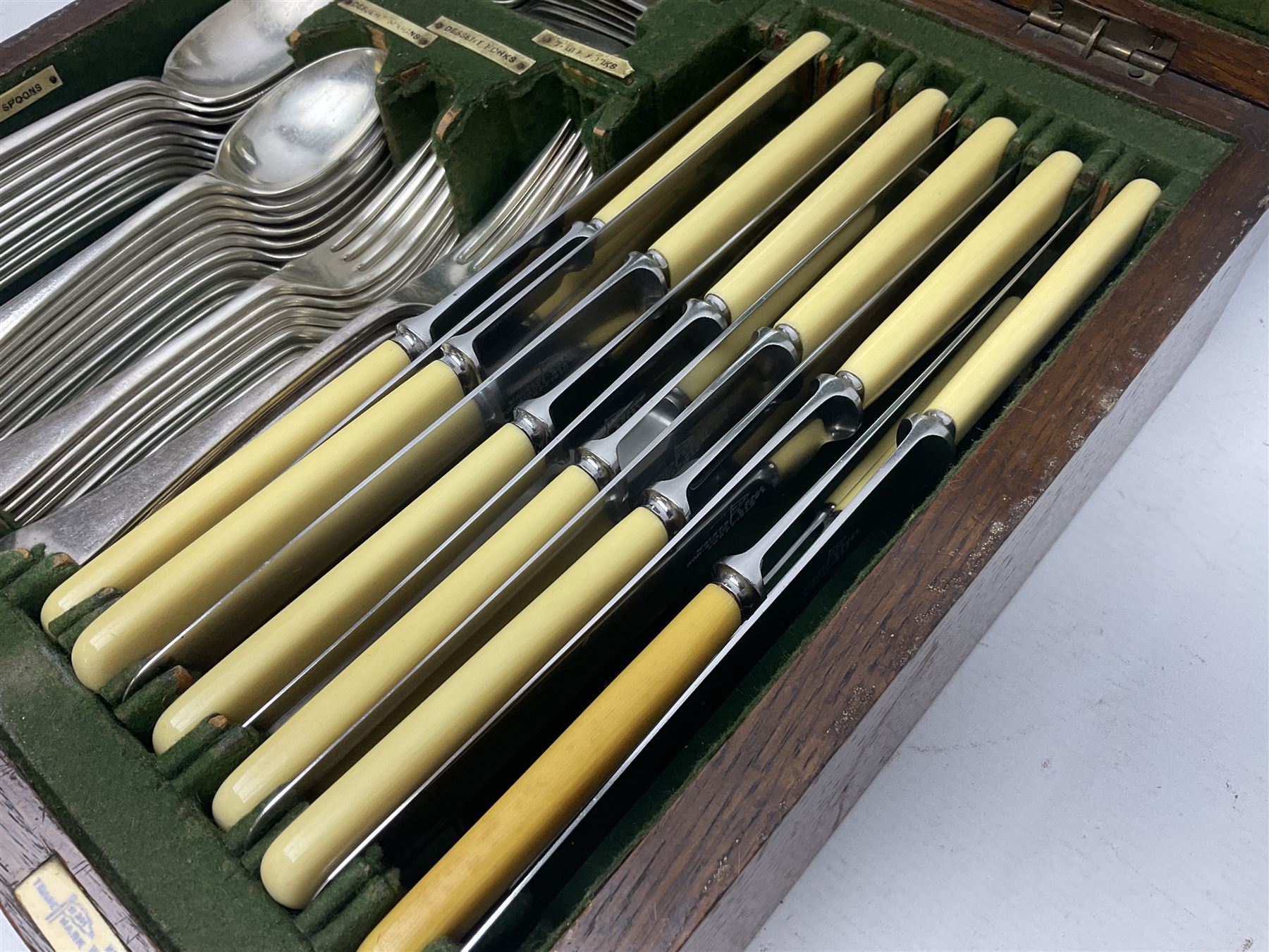 Walker and Hall silver plated canteen of cutlery, oak case, the hinged lid with a engraved brass shield , H12cm, L32cm