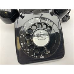 Three black Bakelite telephones with rotary dials, comprising an Ericsson example with base drawer, and two examples marked G.P.O beneath, model no. 706L