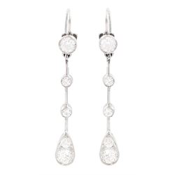 Early 20th century platinum diamond earrings, circa 1930, each pendant milgrain set with o...
